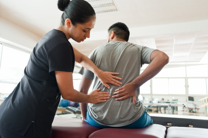 female-massage-therapist-massaging-patients-back-picture-back pain article